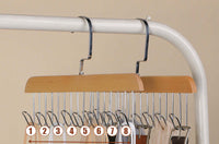 Solid wood eight-hook rack in natural log colour, holding belts and straps